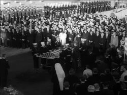 B/W 1963 soldiers + sailors holding American flag over JFK's coffin in Arlington Cemetery Stock Footage