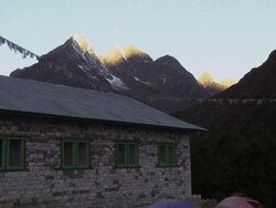 Tents in a valley beneath the Himalayas and the moon in the morning. Stock Footage