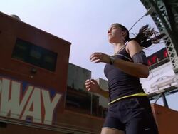 MS TS SLO MO Girl jogging with ipod and earphone on street /New York, New York, United States Stock Footage