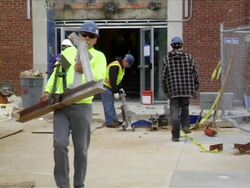 Construction Workers Carry Heavy Iron Beams Stock Footage