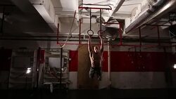 Man exercising on gymnastic rings Stock Footage