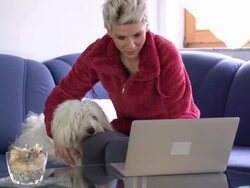 HD DOLLY: Woman And Her Dog Using A Laptop Stock Footage