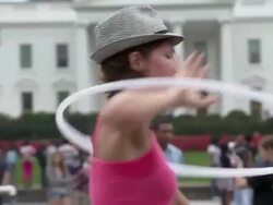 Code Pink hula-hoop rally participants playing with hula hoops in front of White House to protest the U.S. bombing abroad Stock Footage