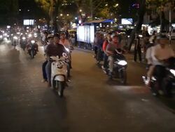 WS LD Motorcycle Traffic Going down Busy Road at Night / Vietnam Stock Footage