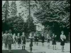 School children exercise in the playground of a village school, The Chilterns, Buckinghamshire, UK  1939 Stock Footage