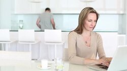 Woman using laptop in kitchen Stock Footage