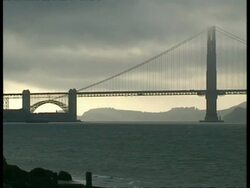 WA view across water to silhouetted Golden Gate Bridge, early morning, San Francisco Stock Footage