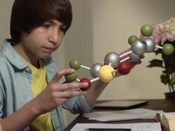 Teen Learns Science by Studying Model of a Molecule CU Stock Footage