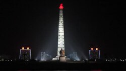 Floodlights illuminate the Tower of Juche in Kim ll Sung Square. Stock Footage