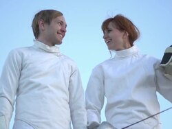 A man and woman fencing on the beach. - Slow Motion Stock Footage