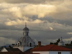 Cloudscape at dusk over the rooftops and church domes of Latacunga, Ecuador Stock Footage
