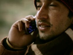 Close-up of Indian young man talking on phone in winter Stock Footage