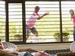 Young man sleeping with his friends planning to enter his home  Stock Footage