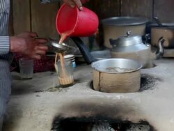 Man preparing Tea on a road side restaurant in India Stock Footage