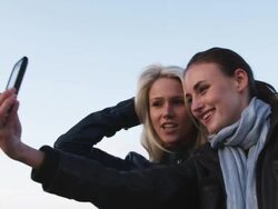 two women taking their own photo Stock Footage