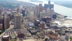 WS AERIAL POV View of modern skyscrapers in downtown with Detroit River in background / Downtown Detroit, Detroit, Michigan, United States Stock Footage