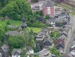 MS AERIAL Shot of railway tracks with houses along streets at Probstzella / Germany Stock Footage