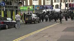 Police Charge in Formation During Riots in Hackney News Clip