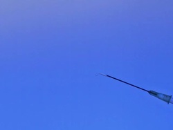 Liquid squirting from syringe against blue background, slow motion Stock Footage