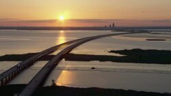 Sunset over Interstate-10 with distant view of Mobile, Alabama skyline. Stock Footage