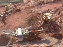 WS Bulldozer loading stones and soil in chrushing machine at quarry / Taben-Rodt, Rhineland-Palatinate, Germany Stock Footage