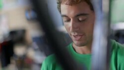 Helpful shop worker chats with customer while scrolling and clicking on tablet computer Stock Footage