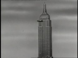 An animated cartoon depicts a B52 Bomber crashing into the Empire State Building; Smoke billows from the Empire State Building after a B52 Bomber crashed into it. News Clip