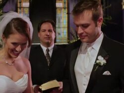 CU of pastor; PULL as bride and groom kiss, then walk toward camera Stock Footage