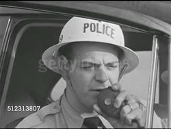 1951: WHAT-IF SCENARIO: SYRACUSE 'AFTER': TD Fire burning on grass near swing set. Policeman in hardhat calling on radio. OPS CENTER: Passing on word about school fire, calling firemen.  1950s Horror, 1950s Sci-fi, Red Scare, McCarthyism. Instructional Video