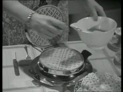 Housewife using a waffle grill, UK  1939 Stock Footage