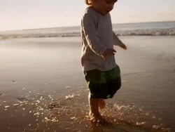 Child walking on beach Stock Footage