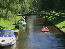 MS View of people enjoying their boat ferry from canal and other boats on side of canal, North Sea North Frisia / Friedrichstadt, Schleswig Holstein, Germany Stock Footage
