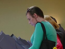 MS ZI Shot of young white middle class woman votes in presidential election at union hall / Toledo, Ohio, United States Stock Footage