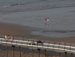 PEOPLE WALKING ON PIER AND BEACH Stock Footage