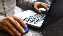 close up hand working on laptop on wood table Stock Footage