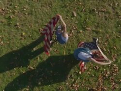 two women dancing with American flags Stock Footage