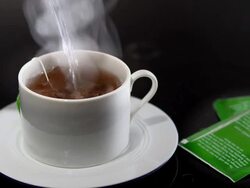  MS Boiling water being poured onto tea bag in white teacup / Los Angeles, California, United States Stock Footage