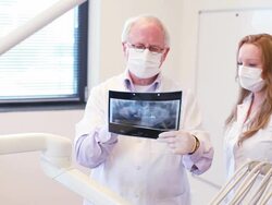Dental and assistant checking xray image. Stock Footage