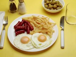 CU Hand serving Chorizo, eggs & chips with drink Stock Footage