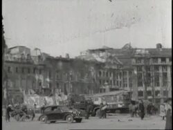 A monument displays posters of U.S. President Harry S. Truman, Soviet Premier Joseph Stalin and British Prime Minister Winston Churchill; Civilians and military personnel walk near the ruins of bombed-out buildings in Berlin, Germany. News Clip