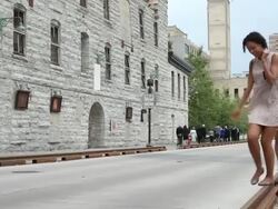 MS PAN Two young girls having fun and balancing on old railroad track in crowded urban waterfront area / Minneapolis, Minnesota, United States Stock Footage