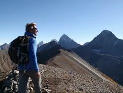 Hiker takes final steps to mountain summit Stock Footage