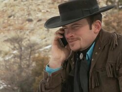 CU Cowboy answering a cell phone call / Shell, Wyoming, United States Stock Footage