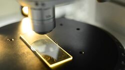 micro panning: Microscopy slide under orange light Stock Footage