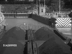 1952: MONONGAHELA RIVER:  VS The Shannopin diesel towboat pushing barges full of coal into the Mon river lock, Captain Bill Cunningham operating levers in pilot house, deckhands securing wire & rope. Dam, waterway, upstream, steel industry Instructional Video