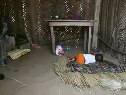 MS Baby sleeping in hut at fisherman village / Togo Stock Footage