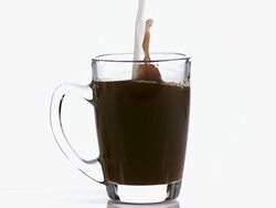 MS SLO MO Milk being Poured in cup of coffee / Vieux Pont, Normandy, France Stock Footage