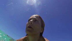 Young woman jumping into water Stock Footage