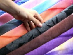 Choosing the right gift; pareos at street market Stock Footage