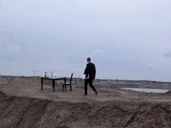WS Young businessman in black suit setting lap- top on  table on top of  bluff in rural area  / Maple Grove, Minnesota, United States Stock Footage